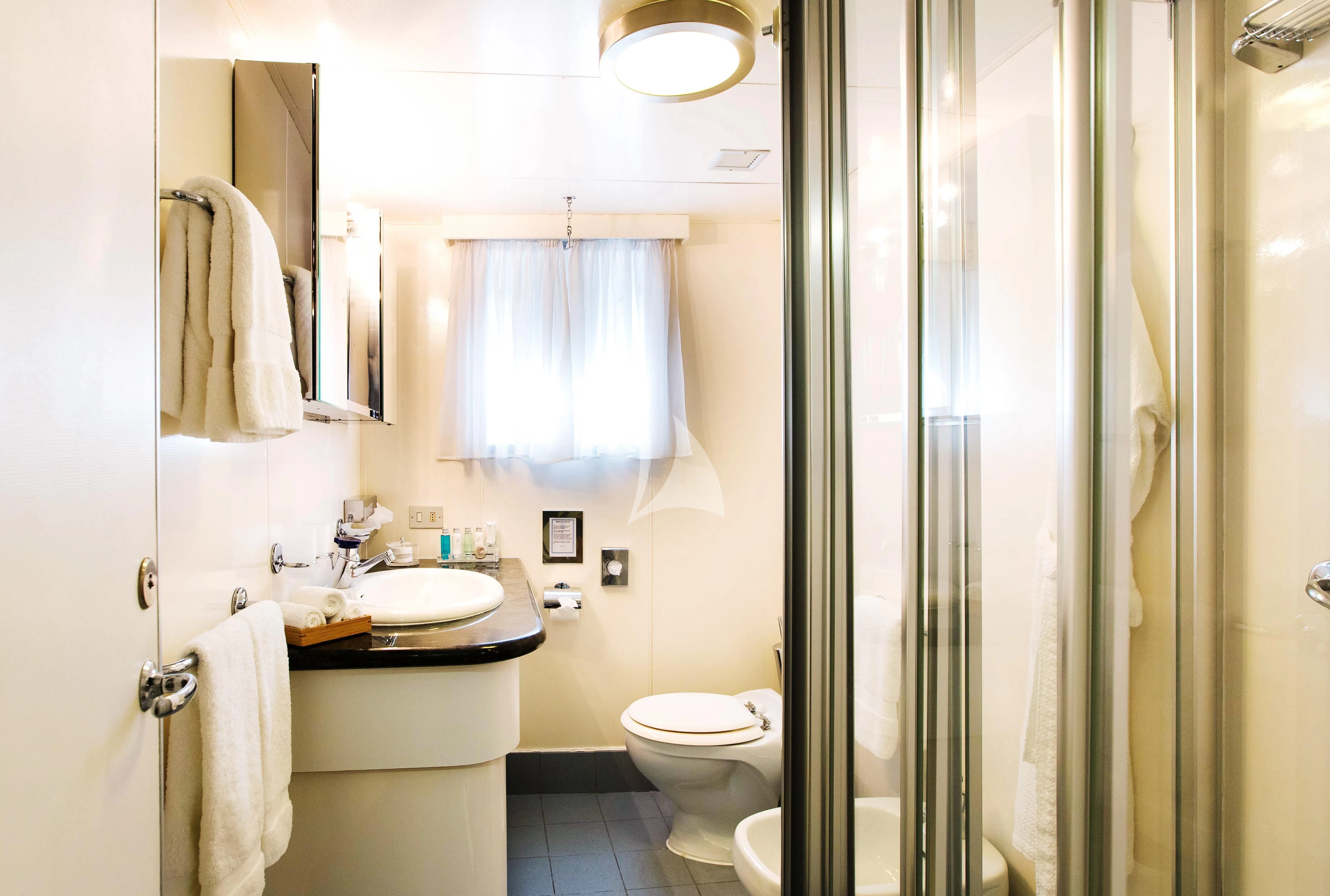 a bathroom with a sink toilet and shower aboard ESMERALDA Yacht for Sale