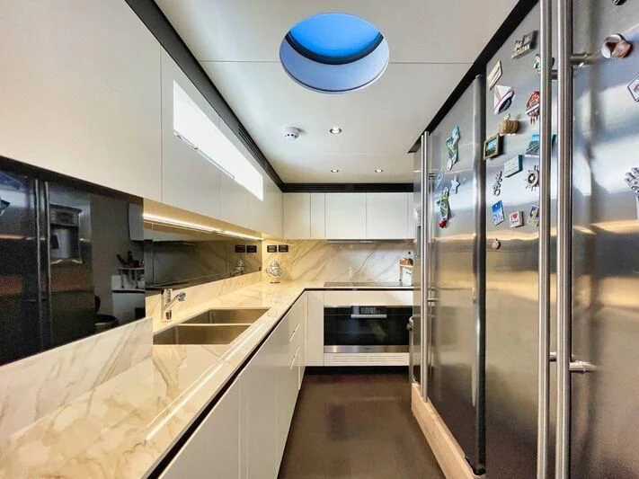 a kitchen with stainless steel appliances aboard WAVE Yacht for Sale