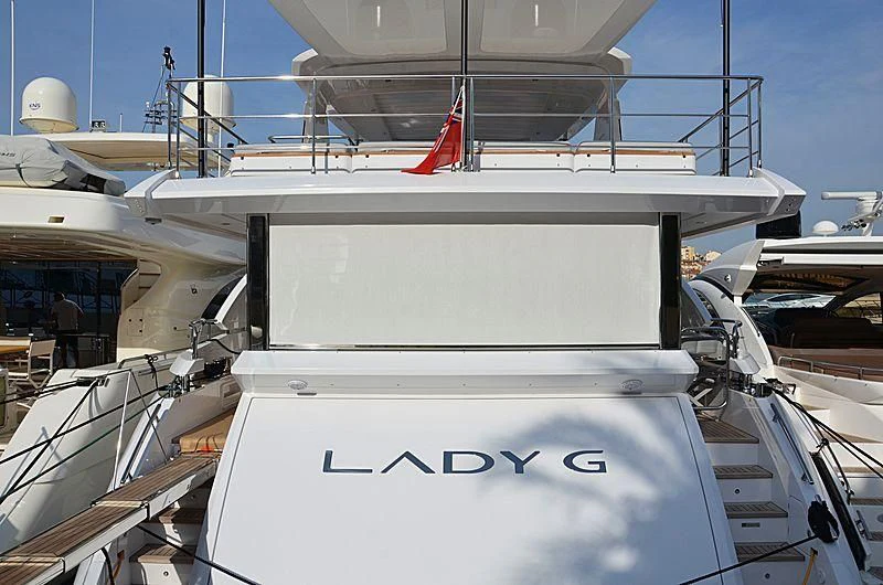 a white boat with a red stripe aboard WAVE Yacht for Sale
