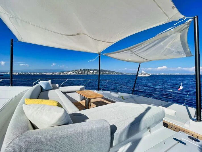 a lounge area with a large umbrella aboard WAVE Yacht for Sale