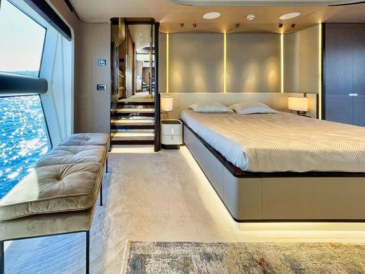 a hotel room with a bed and a couch aboard WAVE Yacht for Sale