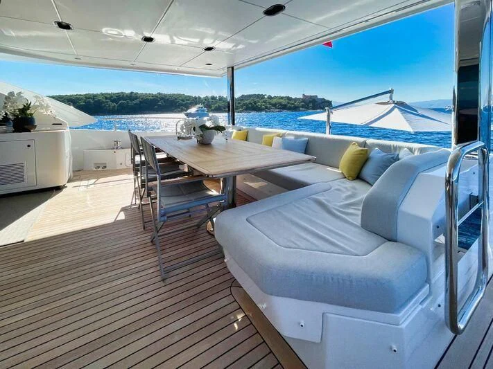 a room with a table and chairs aboard WAVE Yacht for Sale