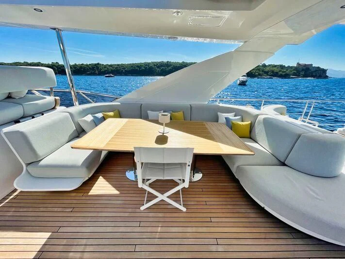 a table and chairs on a deck aboard WAVE Yacht for Sale