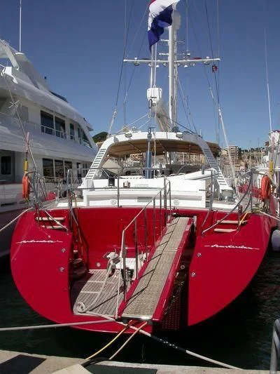 a red boat in the water aboard DELUSHA Yacht for Sale