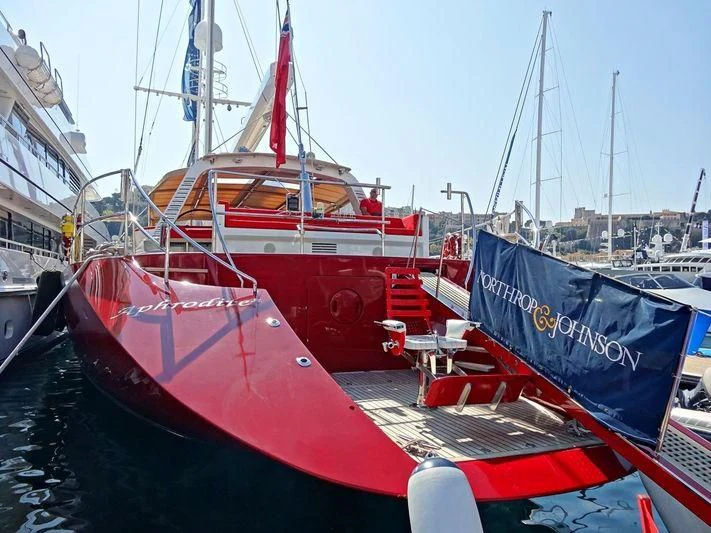 a red boat docked at a pier aboard DELUSHA Yacht for Sale