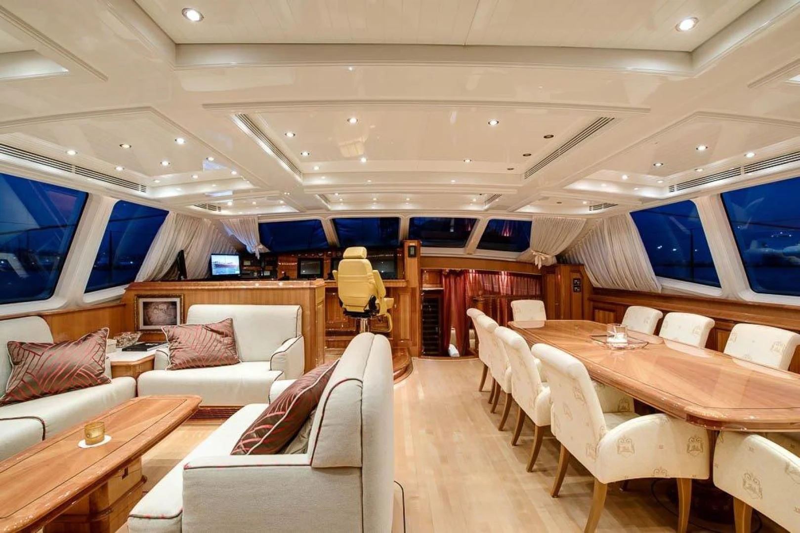 a room with a table chairs and a television aboard DELUSHA Yacht for Sale