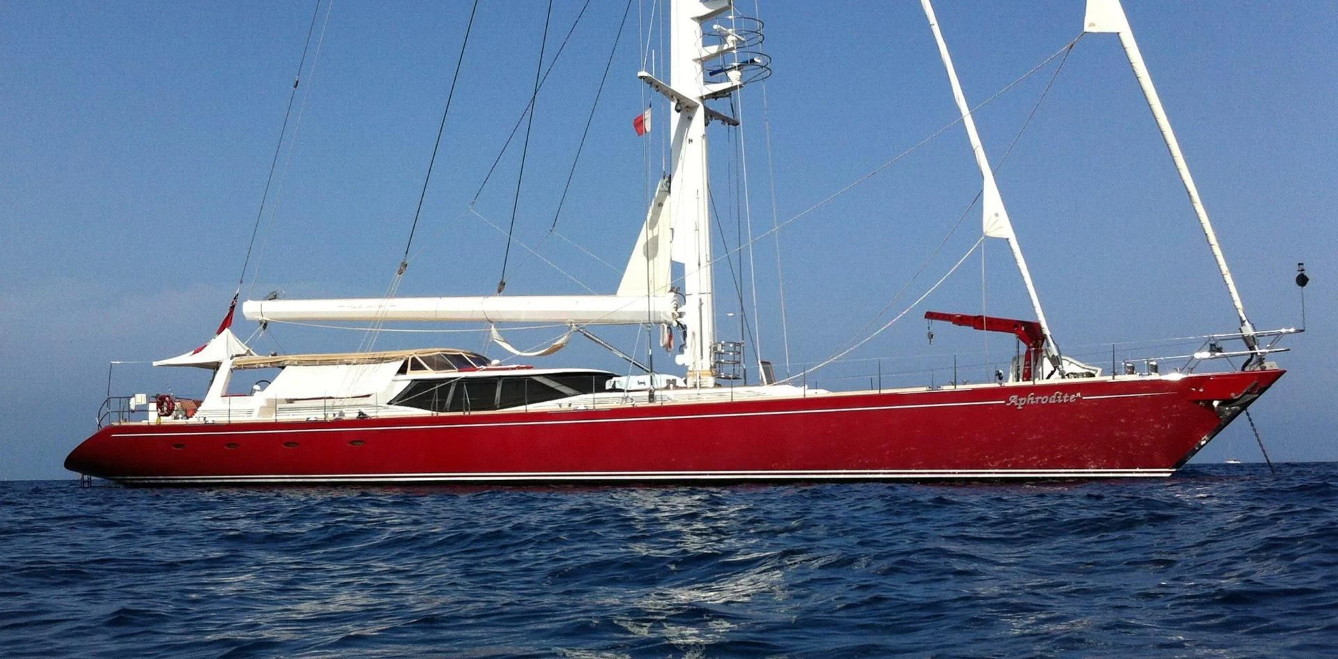 a red and white boat on the water aboard DELUSHA Yacht for Sale