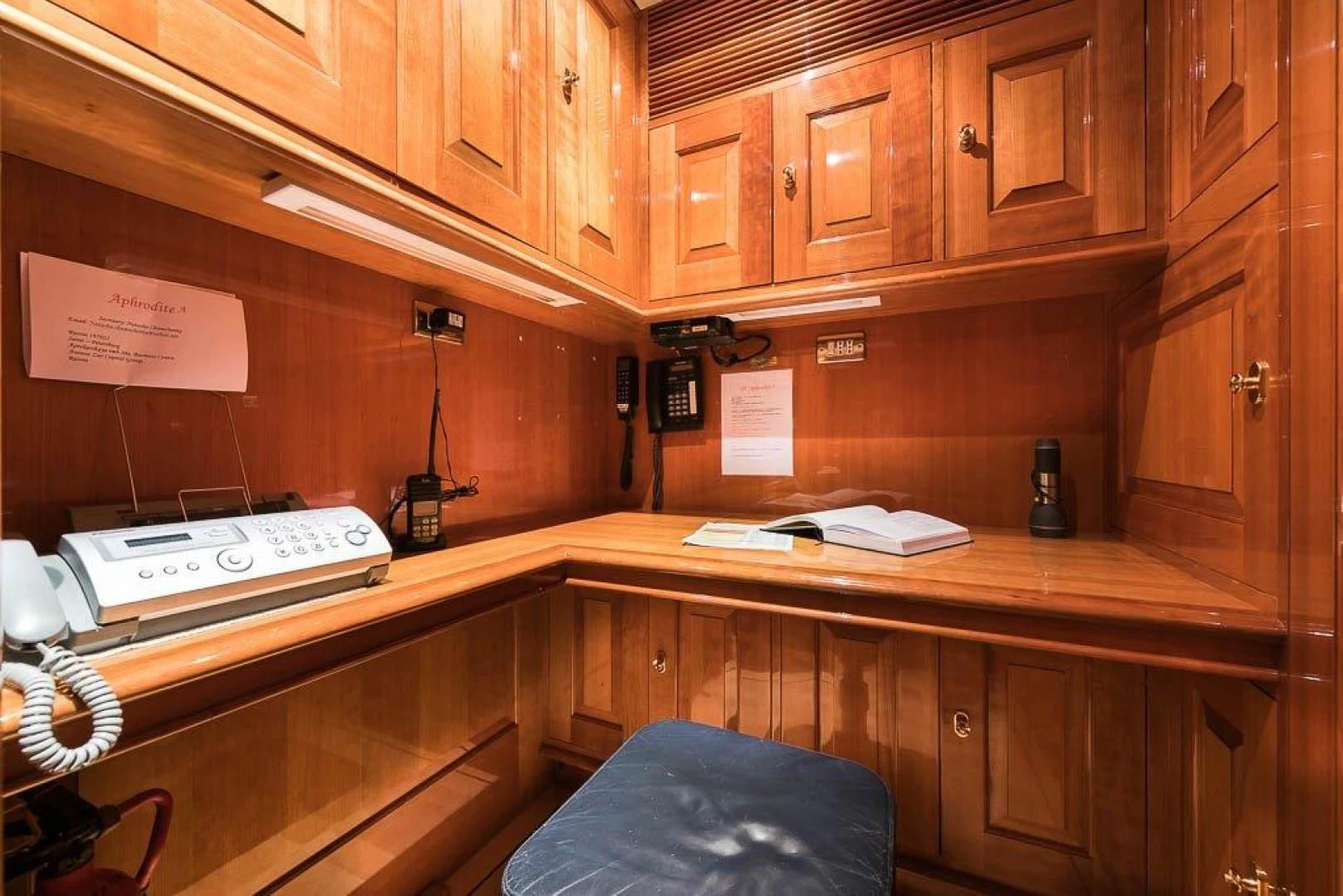 a desk with a telephone and a book on it aboard DELUSHA Yacht for Sale