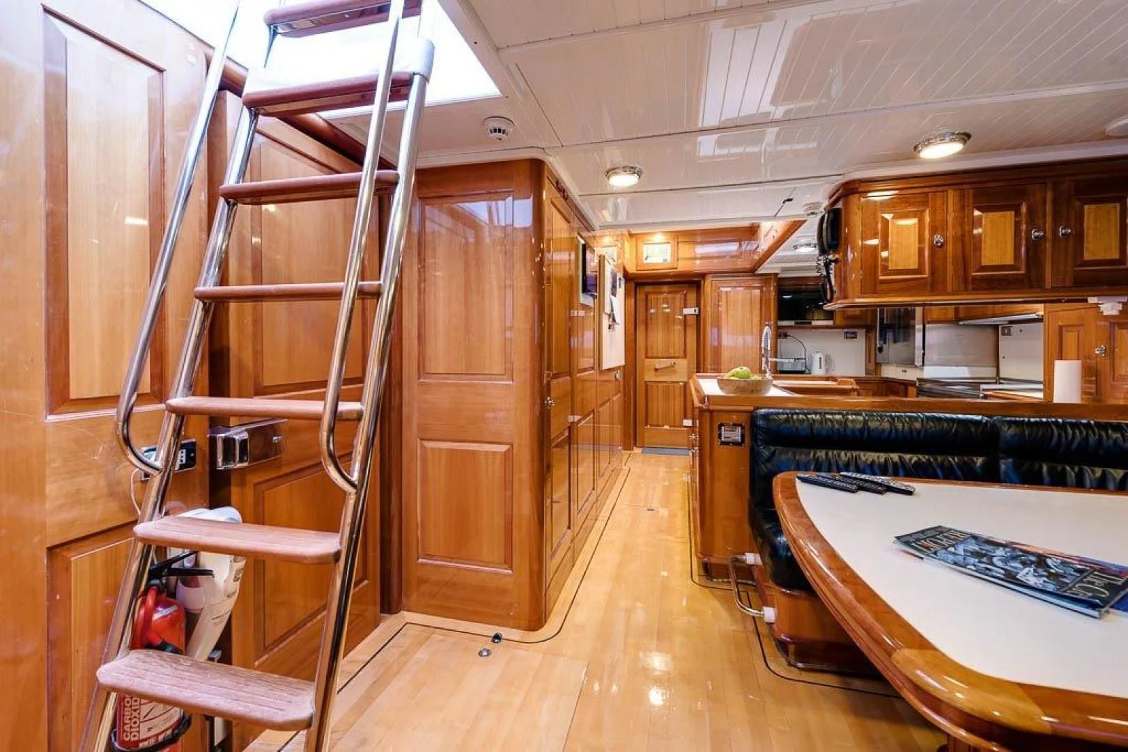 a kitchen with a ladder and a bunk bed aboard DELUSHA Yacht for Sale