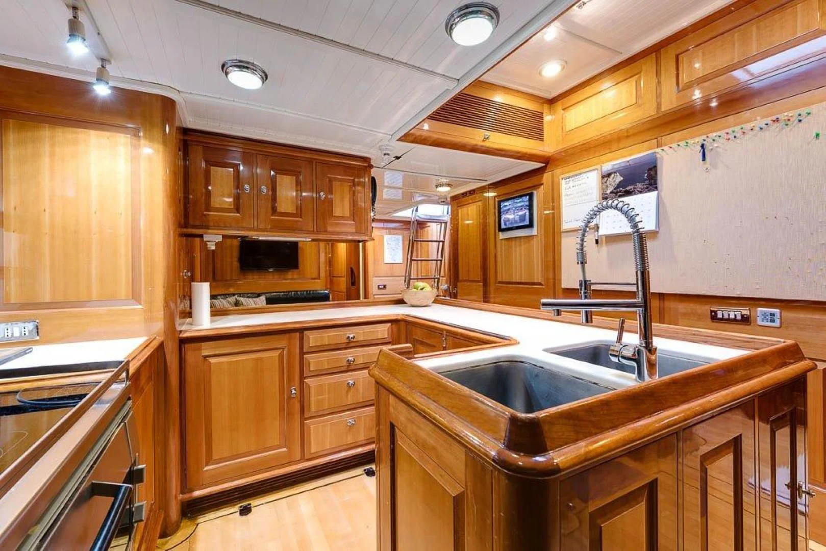 a kitchen with wooden cabinets aboard DELUSHA Yacht for Sale