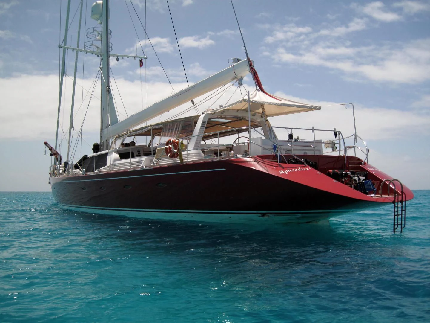 a red and white boat in the water aboard DELUSHA Yacht for Sale