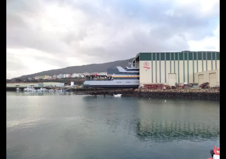 a body of water with buildings and a mountain in the background aboard NEBULA Yacht for Sale