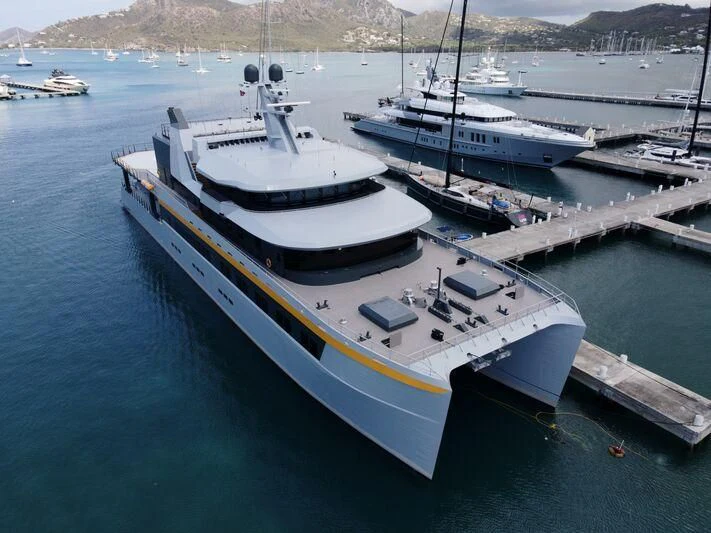 a large white boat in a harbor aboard NEBULA Yacht for Sale