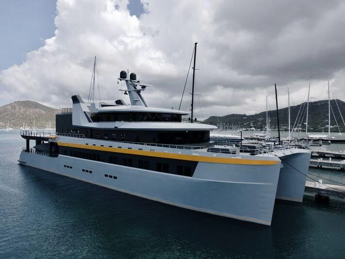 a large white and yellow boat in the water aboard NEBULA Yacht for Sale