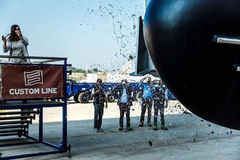 a group of people standing on a stage with a large balloon aboard NP Yacht for Sale