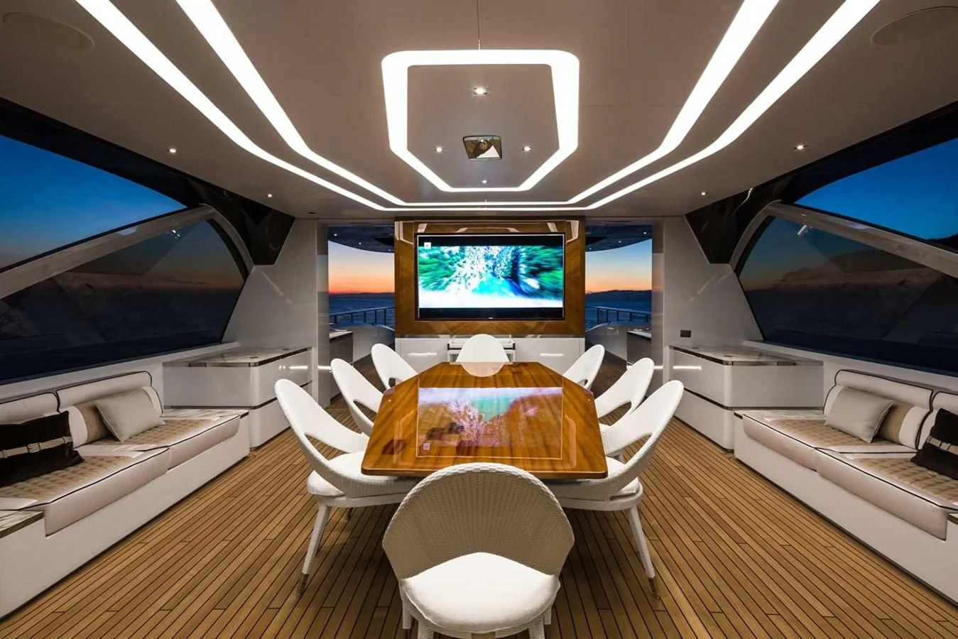 a room with a table and chairs aboard GTT 130 Yacht for Sale
