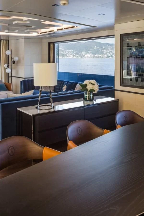 a room with a table and chairs aboard GTT 130 Yacht for Sale