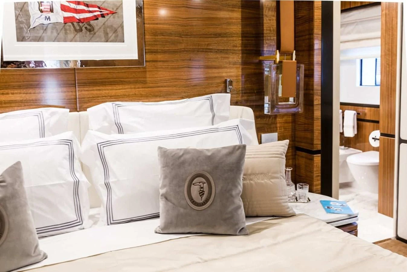 a bed with pillows on it aboard GTT 130 Yacht for Sale