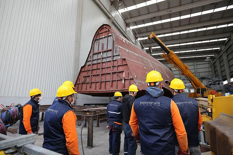 a group of people wearing hardhats and helmets aboard FAMILIA Yacht for Sale