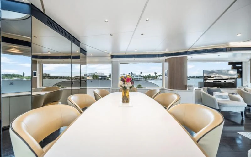 a room with a table and chairs aboard GAS Yacht for Sale