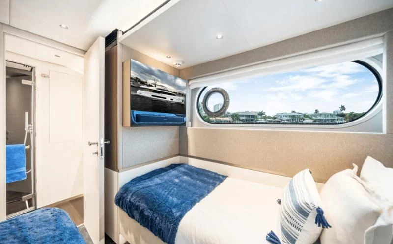 a room with a bed and a window aboard GAS Yacht for Sale