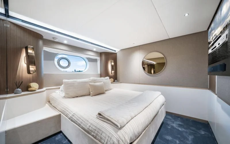 a bedroom with a bed and a mirror aboard GAS Yacht for Sale