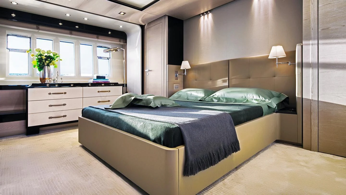 a bedroom with a bed and a desk aboard GAS Yacht for Sale