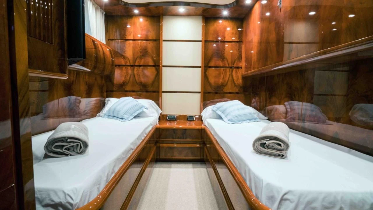 a room with beds and a mirror aboard B5 Yacht for Sale