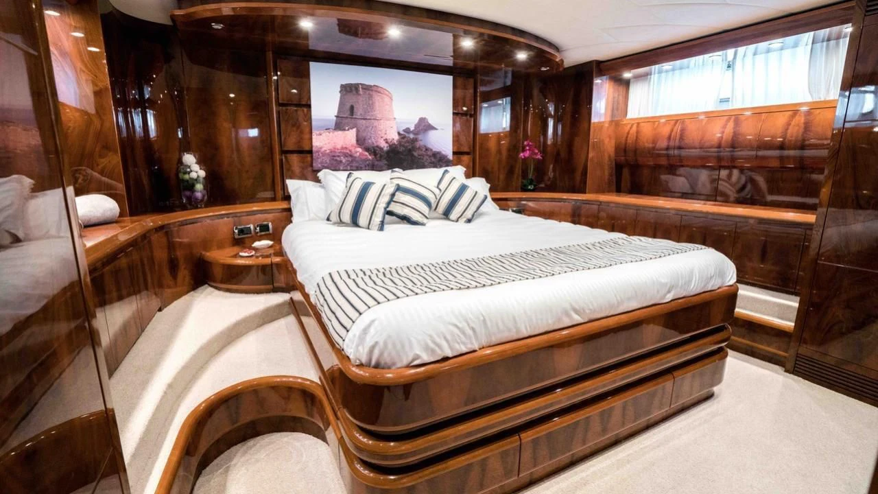 a room with a bed and a mirror aboard B5 Yacht for Sale