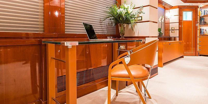 a desk with a laptop on it aboard B5 Yacht for Sale