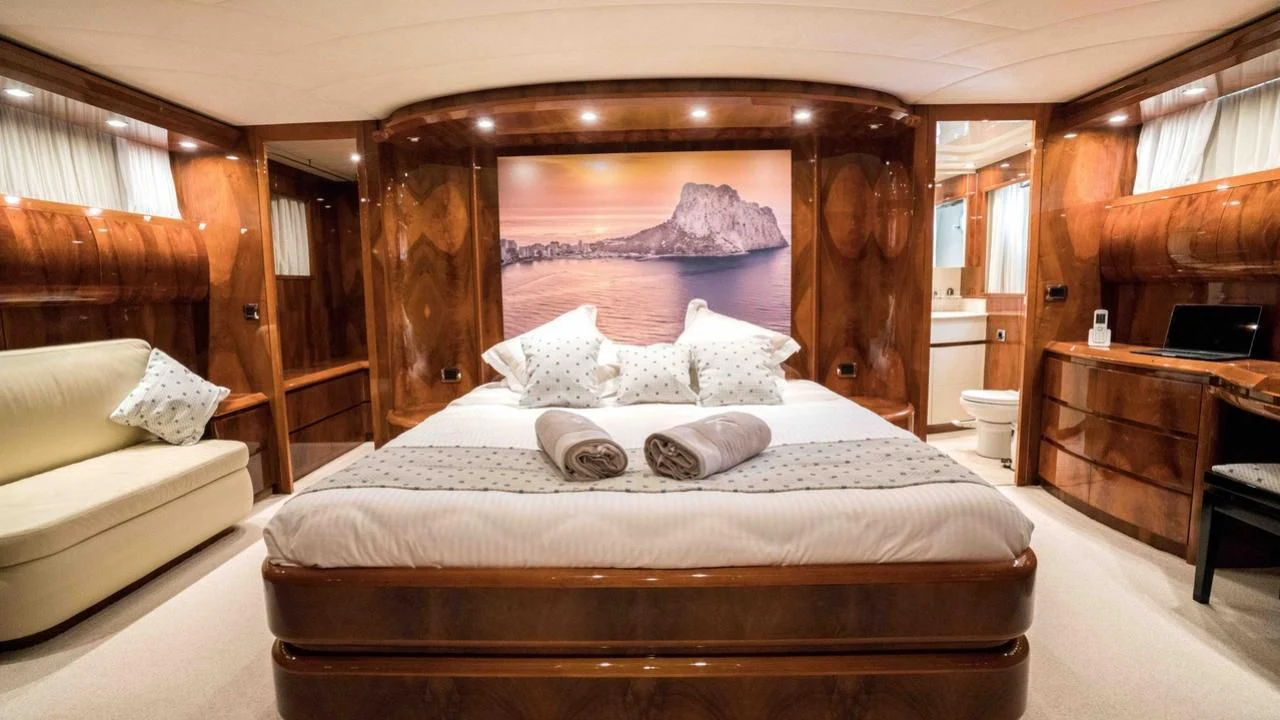 a bed with white sheets aboard B5 Yacht for Sale
