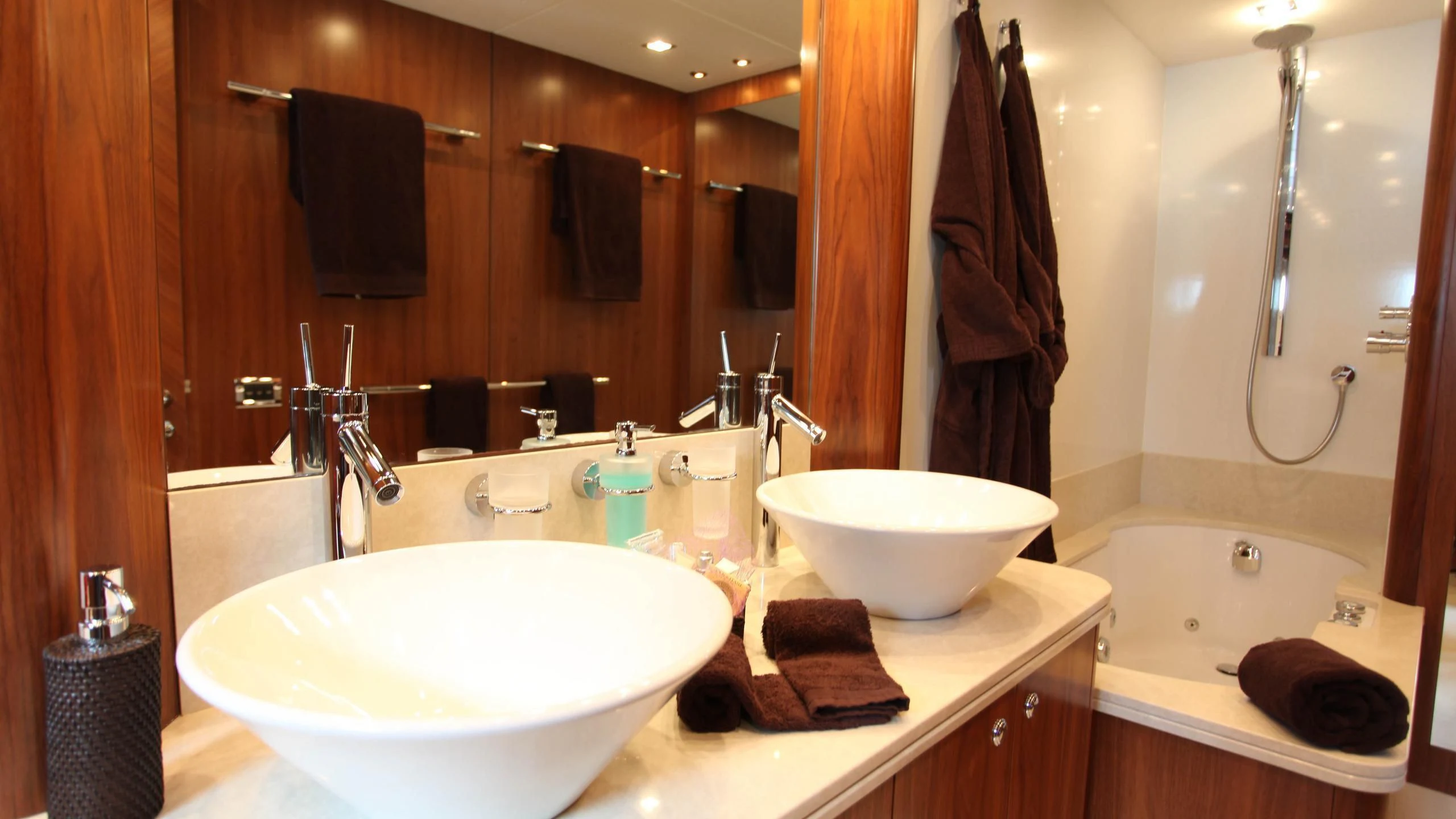 a bathroom with two sinks and a large mirror aboard KEFI Yacht for Charter