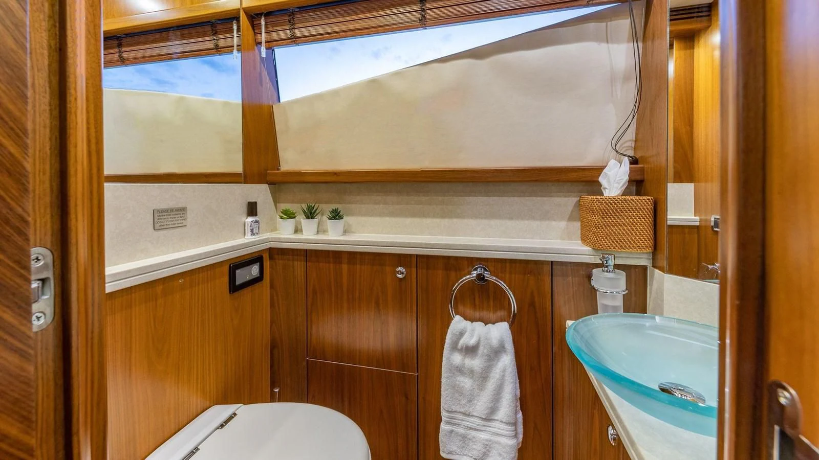 a bathroom with wooden cabinets aboard KEFI Yacht for Charter