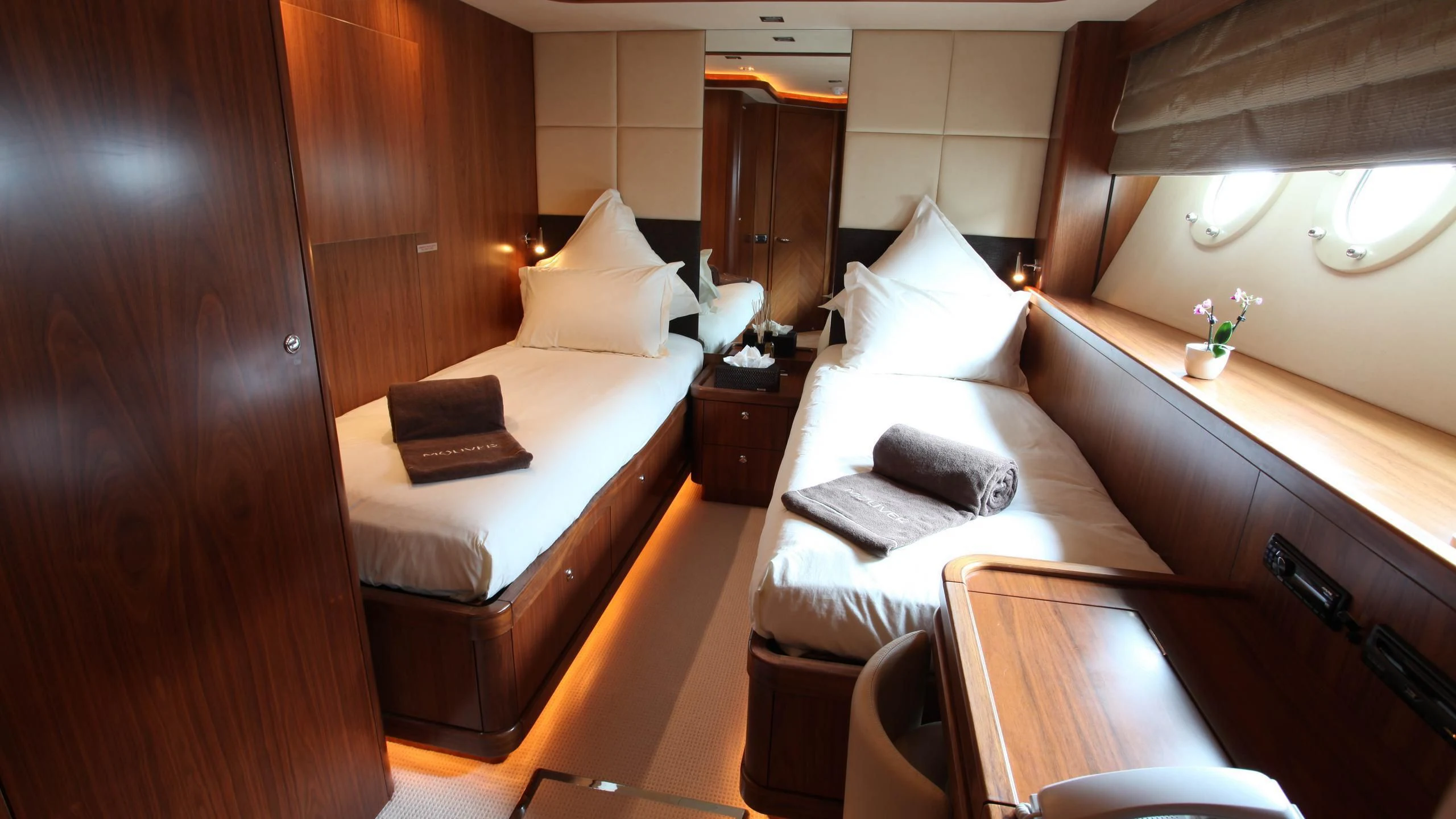 a hotel room with a bed and a desk aboard KEFI Yacht for Charter