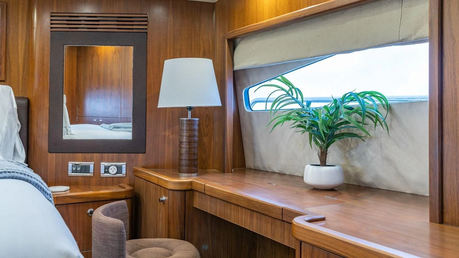 a room with a television and a plant in it aboard KEFI Yacht for Charter