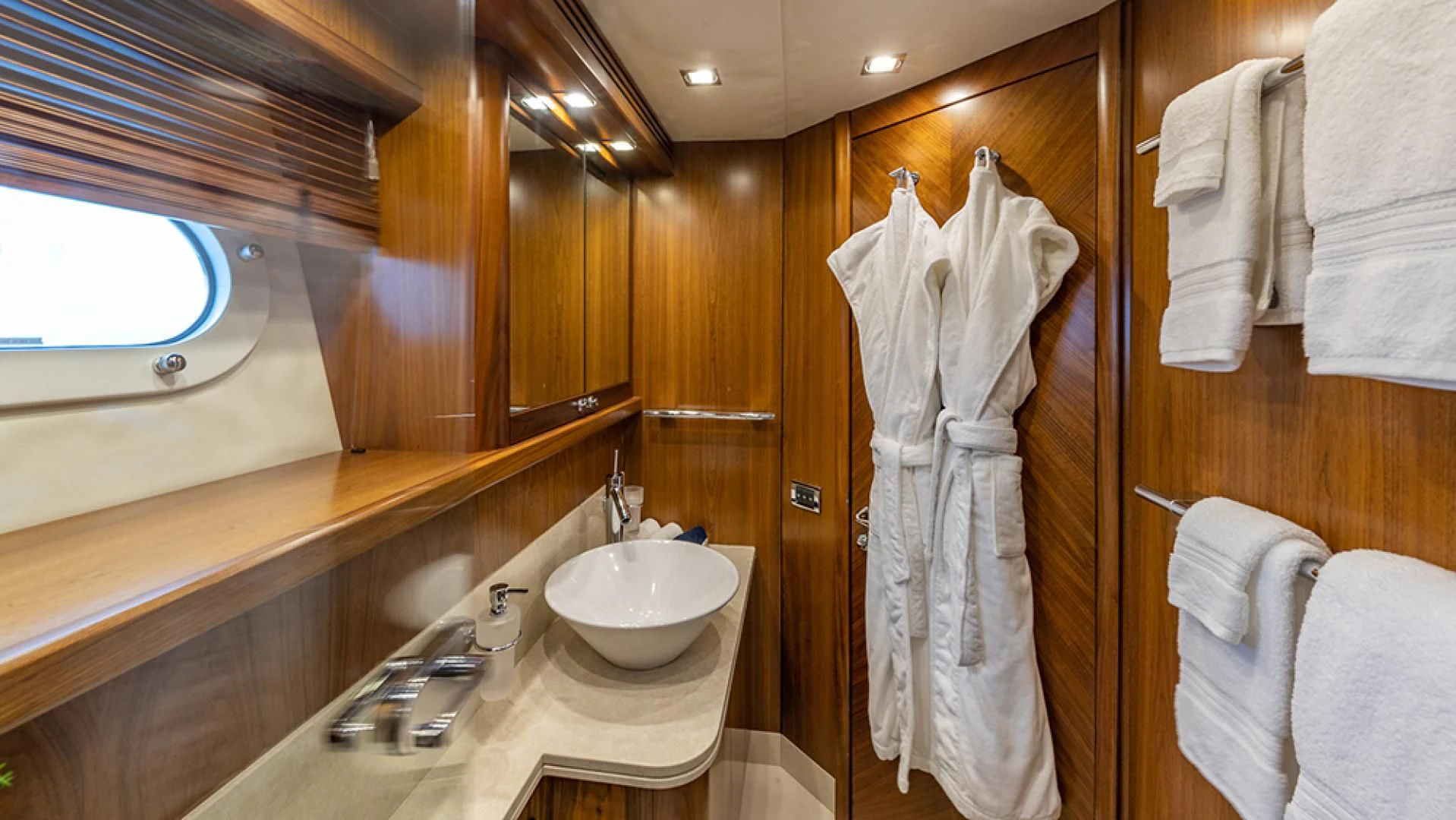 a bathroom with a sink and towels aboard KEFI Yacht for Charter