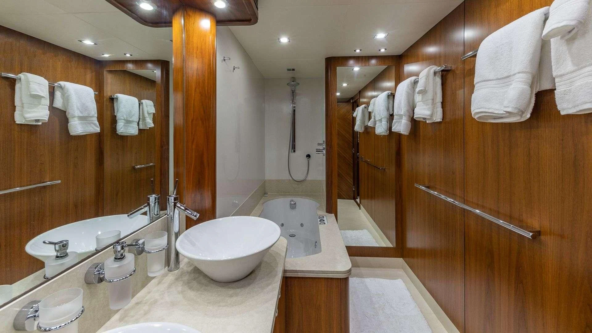 a bathroom with a large mirror aboard KEFI Yacht for Charter