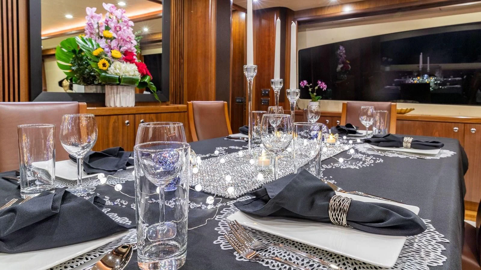 a table with glasses and napkins aboard KEFI Yacht for Charter