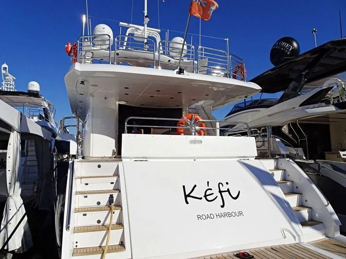 a white boat with a white sign aboard KEFI Yacht for Charter