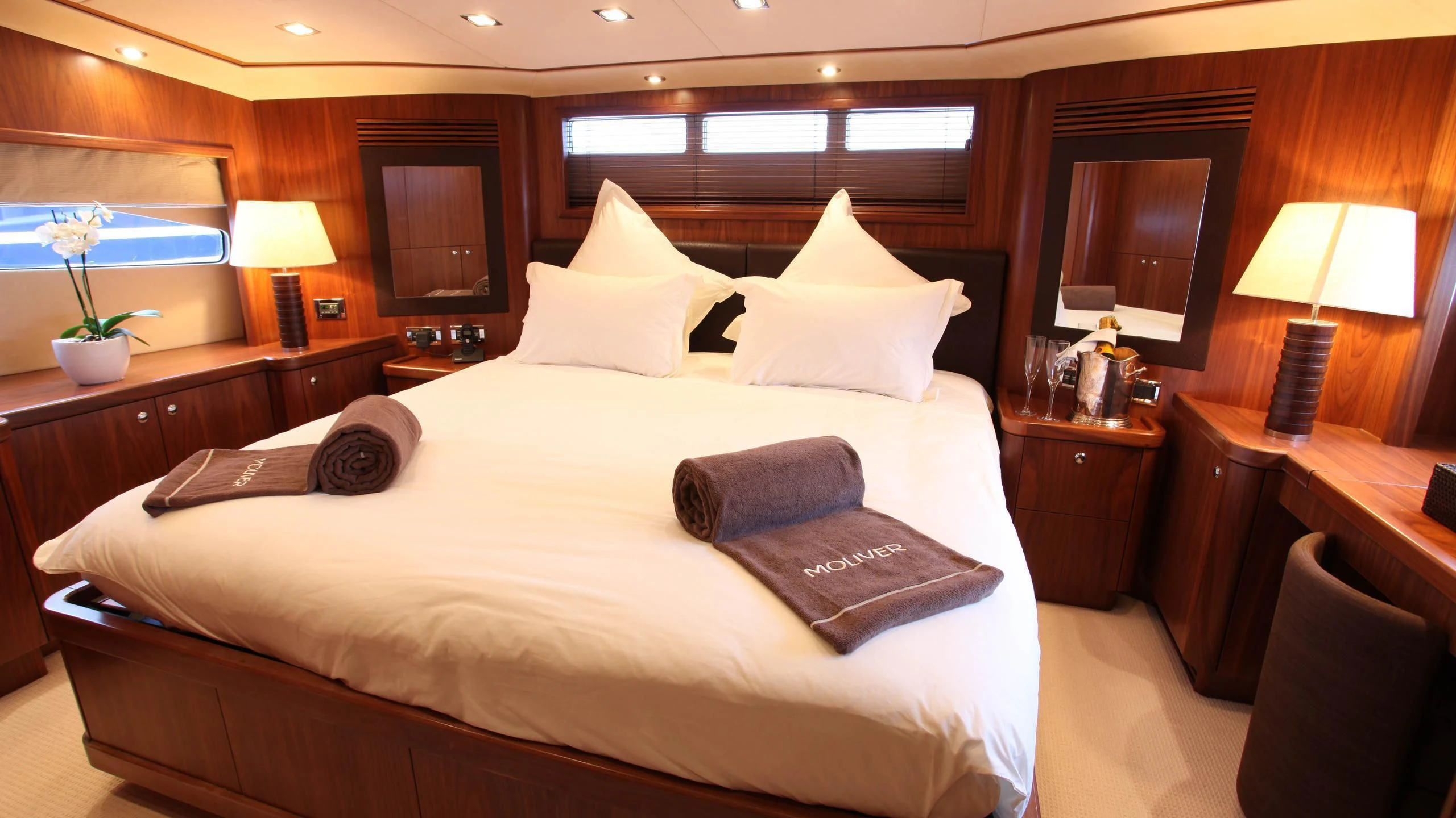 a hotel room with a bed and a television aboard KEFI Yacht for Charter