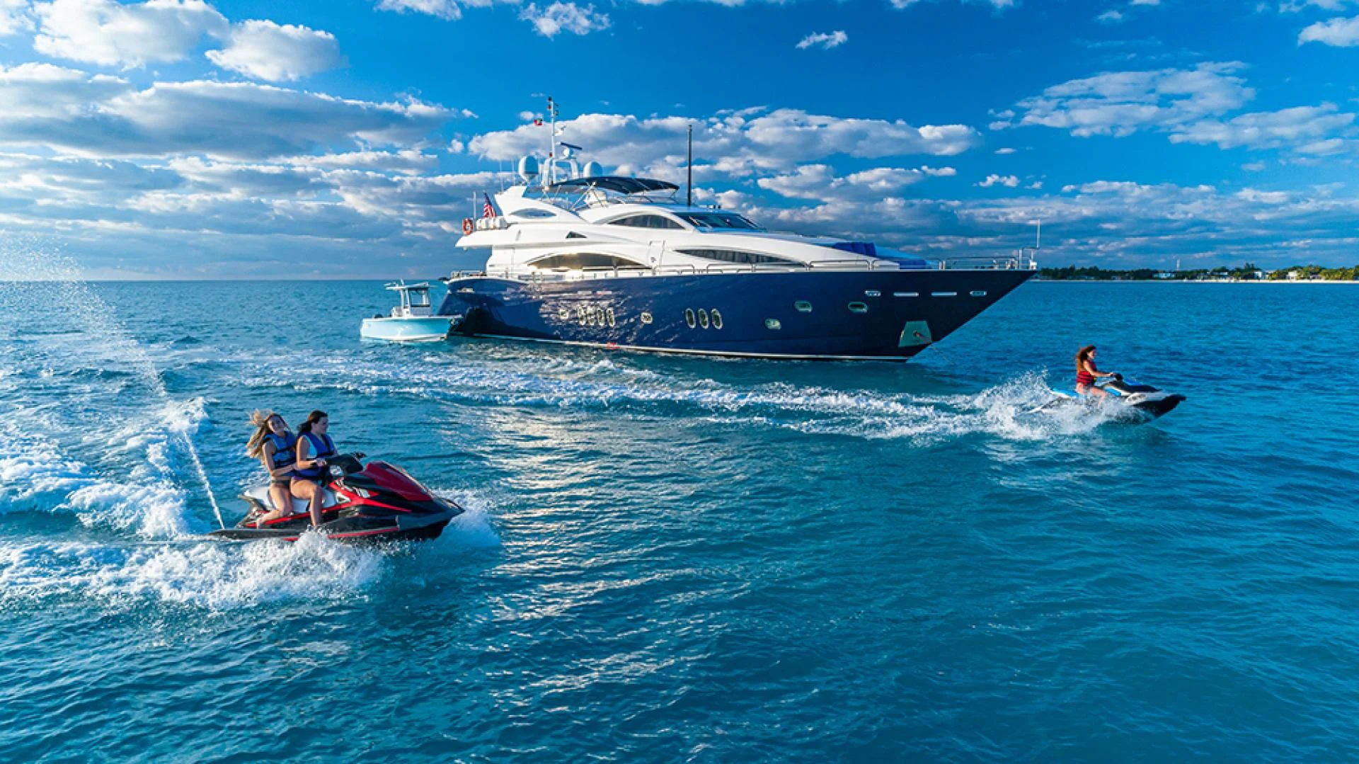 a boat and a couple of people on the water aboard KEFI Yacht for Charter