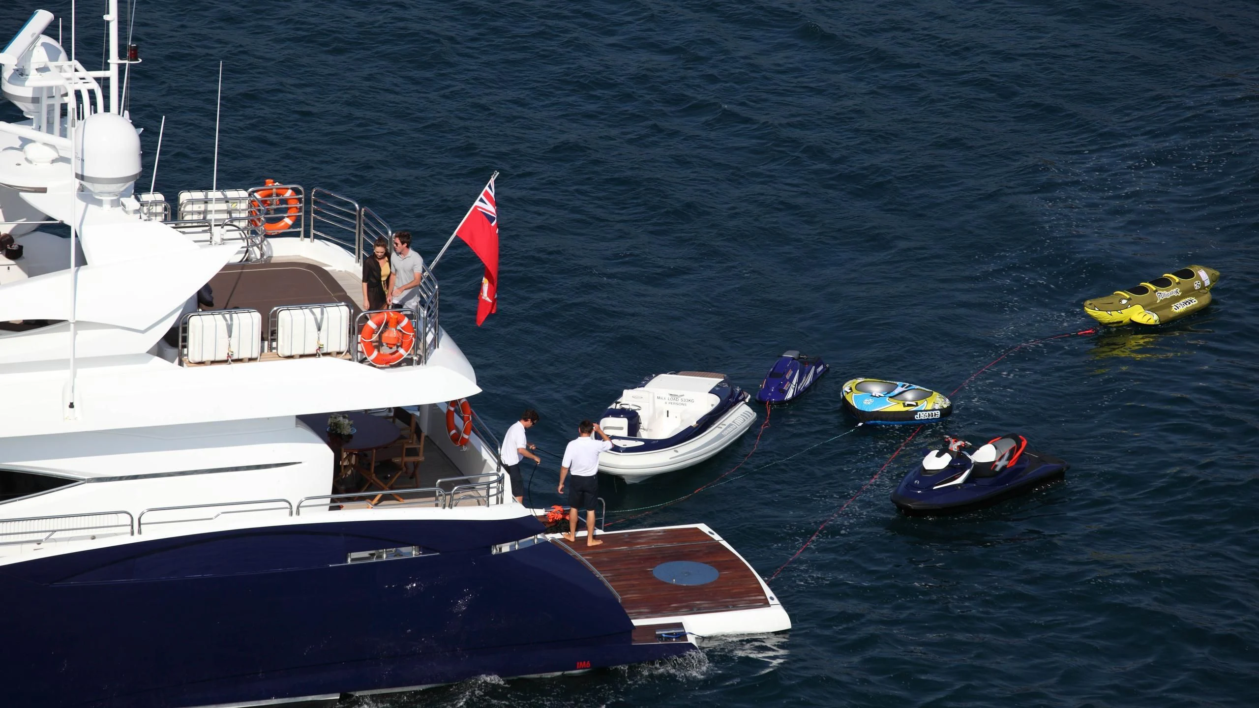 a boat with a flag on it aboard KEFI Yacht for Charter