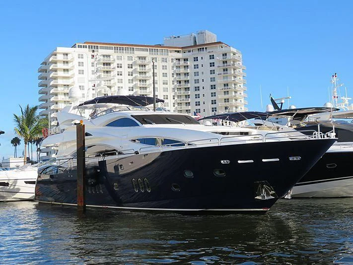 a boat docked in front of a large building aboard KEFI Yacht for Charter