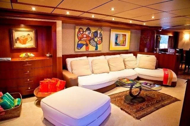a living room with a couch and a coffee table aboard MARANATHA Yacht for Sale