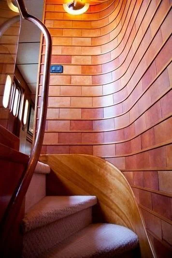 a staircase with a wood railing aboard MARANATHA Yacht for Sale