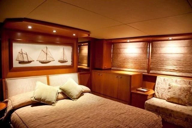 a room with a bed and a chair aboard MARANATHA Yacht for Sale