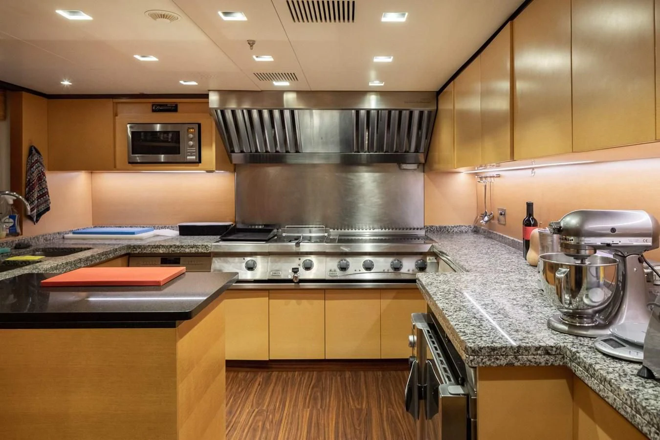 a kitchen with a stove and a microwave aboard LAMMOUCHE Yacht for Sale