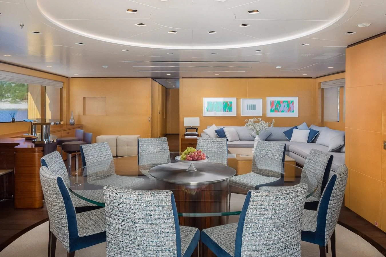 a living room with a table and chairs aboard LAMMOUCHE Yacht for Sale