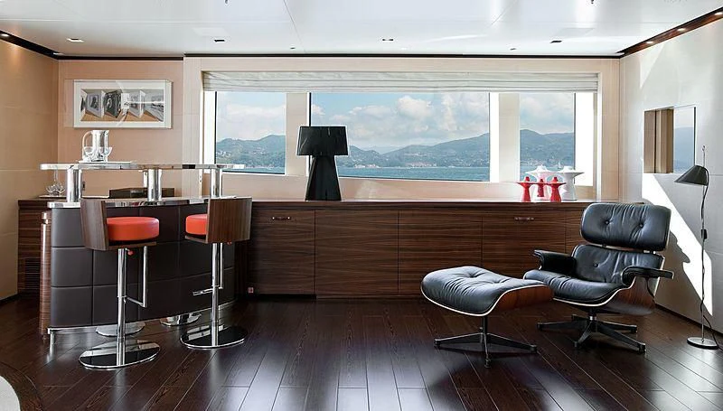 a room with a table chairs and a window aboard LAMMOUCHE Yacht for Sale