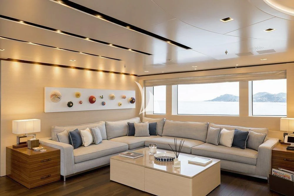 a living room with a couch and a table aboard LAMMOUCHE Yacht for Sale